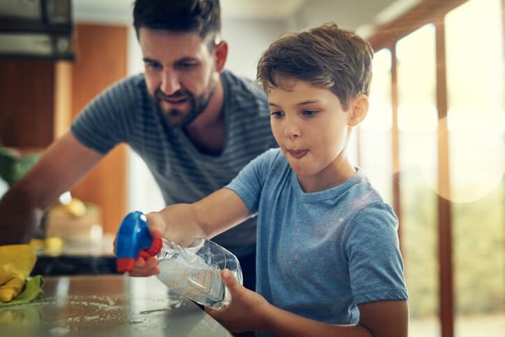 Father & Son Duo Tidying Up The Home Together.